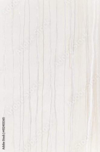 Background of wall dripping with pale pastel beige paints. Abstract pastel watercolors on a white concrete wall.