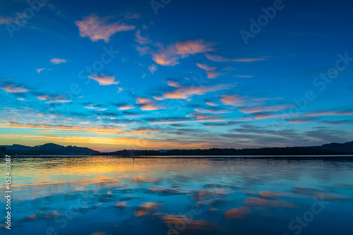 Sunrise waterscape with high cloud and reflections © Merrillie