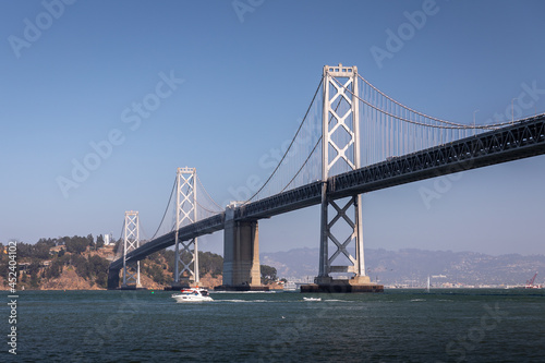 Landscape of San Francisco - Oakland bay bridge with running boat. photo