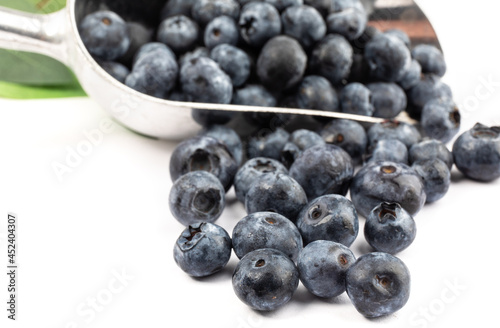 fresh ripe blueberries in a baker's scoop isolated on white