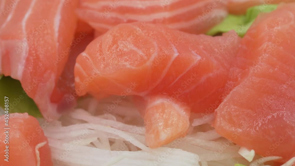 Close-up rotates view of spicy salmon salad with vegetable, Red fish healthy salad rotating in front of camera Close-up rotates view of spicy salmon salad with vegetable, Red fish healthy salad rotating in front of camera