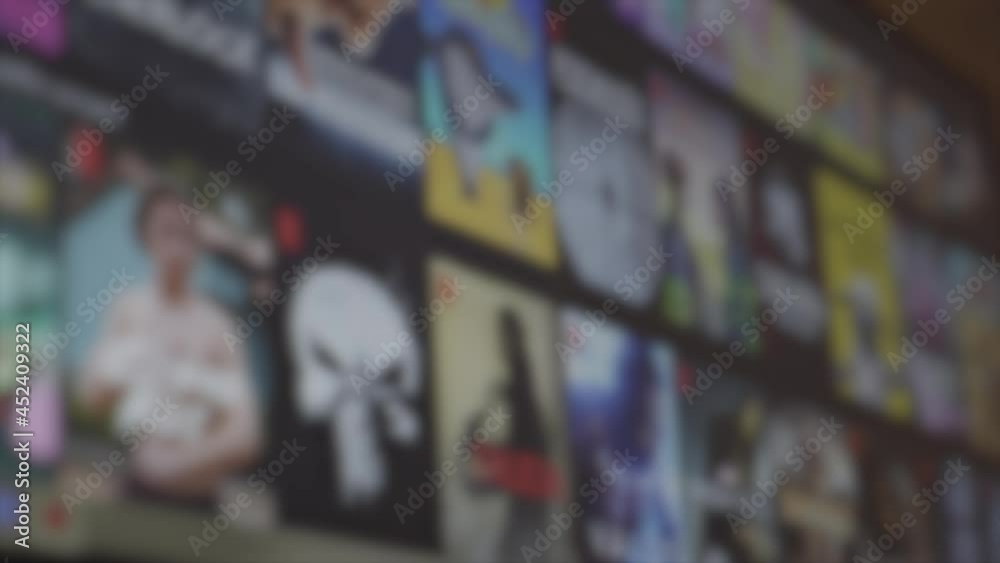 Blurred video of browsing movie catalog. Online film searching. Closeup