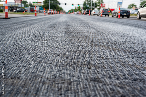 Low angle shot across a scarified street under construction with lanes on either side blocked off. photo