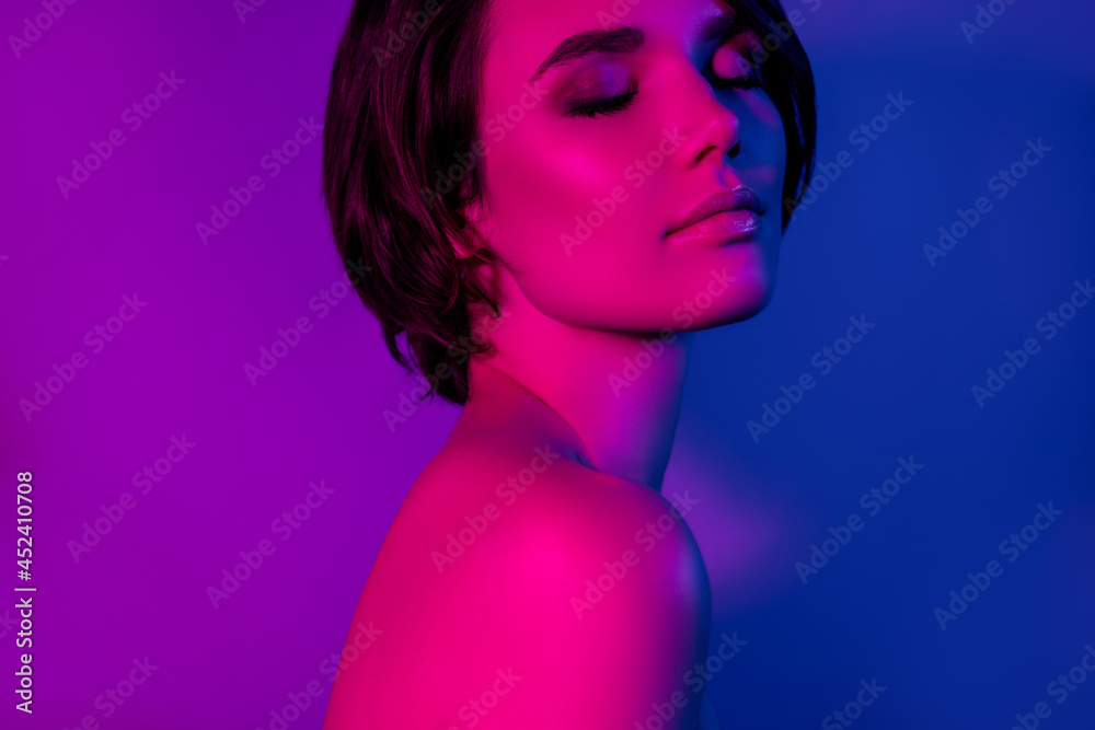Side profile photo portrait peaceful girl nude shoulders wearing bob hairdress dreamy isolated blue color background Side profile photo portrait peaceful girl nude shoulders wearing bob hairdress dreamy isolated blue color background