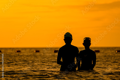 silhouettes of people on the sea, warm sunshine on the morning, at Haadrin beach, koh phangan, surathhani , thailand © kongkiat chairat