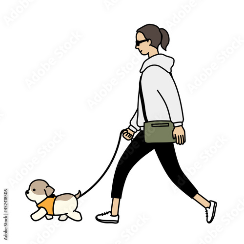 犬の散歩。子犬とサングラスを掛けた女性