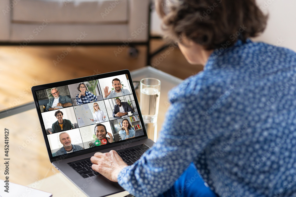Aged business woman using laptop for having virtual team meeting on video call with different people, work from home office or coworking, online meeting, briefing, brainstorming - obrazy, fototapety, plakaty 