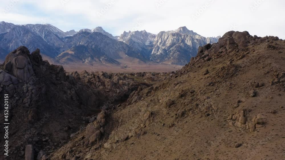Aerial Over Dry Hillside With Epic Mountain Views Of Eastern Sierra. Dolly Back, Establishing Shot Aerial Over Dry Hillside With Epic Mountain Views Of Eastern Sierra. Dolly Back, Establishing Shot