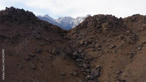 Aerial Ove rRocky Hillside With Epic Mountain Views Of Eastern Sierra. Dolly Forward, Establishing Shot photo