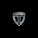 The logo of the letter T emblem. The design is accompanied by a silver shield. Letter shield logo design concept template