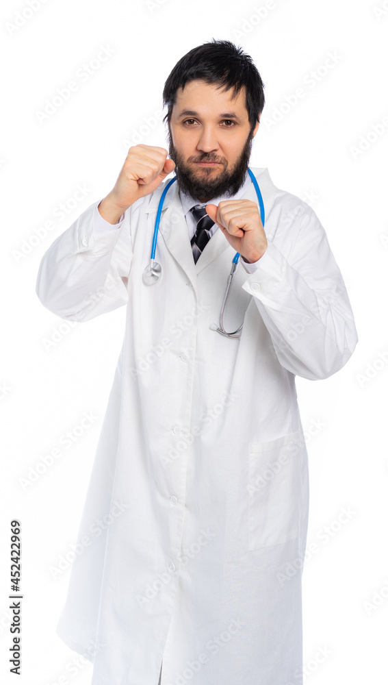 the doctor stands in a boxing stance and looks at us. portrait of a medic. medicine fights disease the doctor stands in a boxing stance and looks at us. portrait of a medic. medicine fights disease