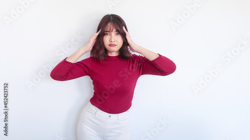 Thinking gesture of Asian beautiful girl with red shirt in white background © Reezky