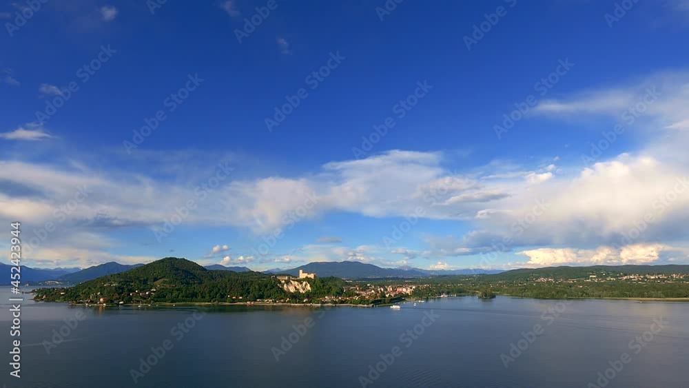 Timelapse of Maggiore lake with ferry boat navigating toward Angera castle, Italy Timelapse of Maggiore lake with ferry boat navigating toward Angera castle, Italy