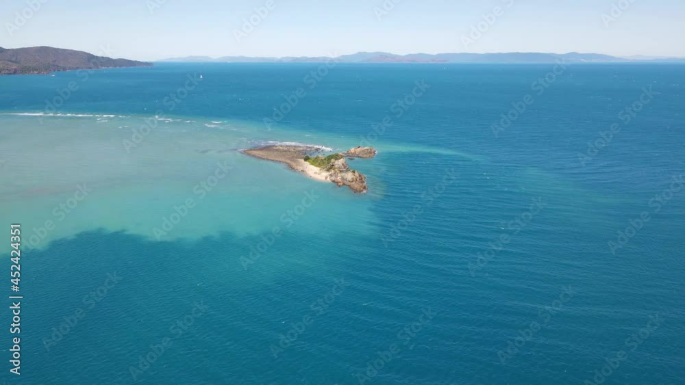 Aerial View Of Bird Island By Turquoise Blue Sea At Daytime - Seascape At Whitsunday Island In QLD, Australia. Aerial View Of Bird Island By Turquoise Blue Sea At Daytime - Seascape At Whitsunday Island In QLD, Australia.