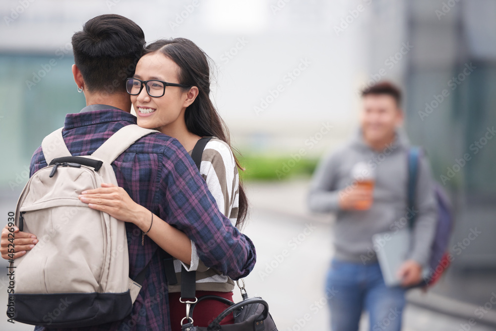Smiling teenage girl happy to see her fellow student after spring break Smiling teenage girl happy to see her fellow student after spring break