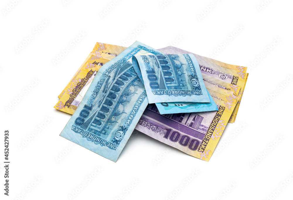 A pile of thousand and hundred taka bangladesh banknotes on an isolated white background A pile of thousand and hundred taka bangladesh banknotes on an isolated white background