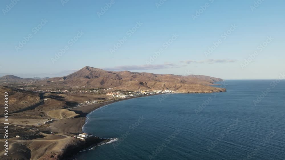 aerial drone video of a small village on the coast side of the island Fuerteventura while sunset. aerial drone video of a small village on the coast side of the island Fuerteventura while sunset.