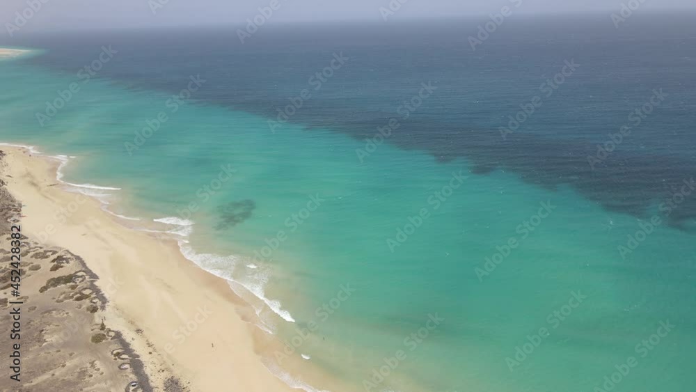 aerial drone shot of a beautiful beach with clear water in Fuerteventura in the Canary Islands aerial drone shot of a beautiful beach with clear water in Fuerteventura in the Canary Islands