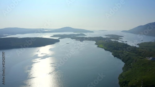 Barnaderg Bay, Letterfrack, Connemara, County Galway, Ireland, July 2021. Drone slowly tracks south while facing west to Rosleague, with Dawros Beg and the North Atlantic Ocean in the distance photo