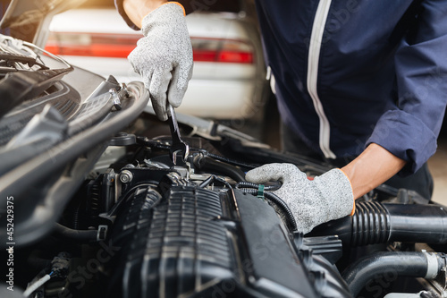 Automobile mechanic repairman hands repairing a car engine automotive workshop with a wrench, car service and maintenance,Repair service.