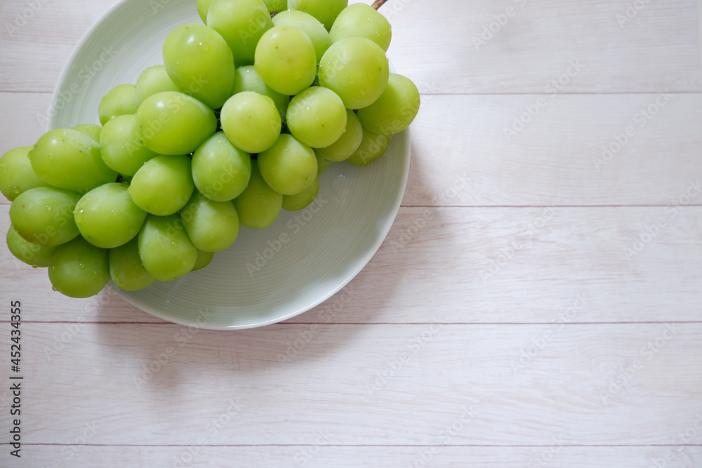 Fresh Muscat on white wooden background. Shine Muscat, Fresh grape. Green fresh grape with water drops. Fresh Muscat on white wooden background. Shine Muscat, Fresh grape. Green fresh grape with water drops.