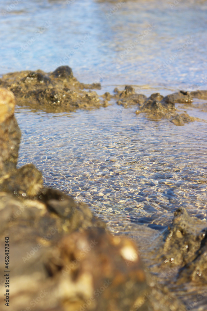 Obraz premium rocks on the beach, crystal clear