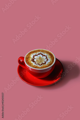 Mocha coffee in a red mug decorated with caramel and chocolate motifs. Place a glass on a dark pink background.