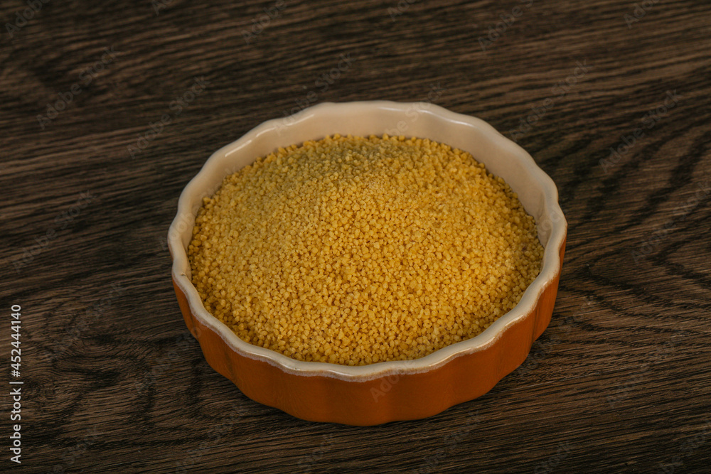Raw cous cous heap in the bowl Raw cous cous heap in the bowl