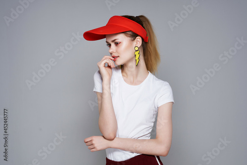 woman in red cap yellow earrings summer fashion glamor