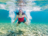 Girl with diving mask underwater in the sea