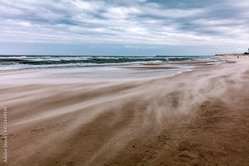 Stormy sea, wind blowing sand on the beach Stormy sea, wind blowing sand on the beach