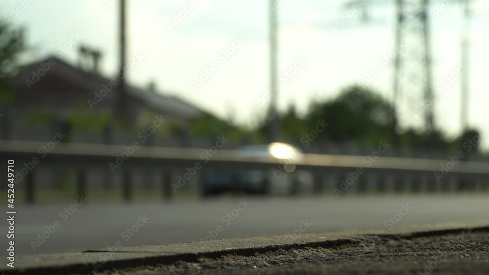 Defocus views city traffic. Cars move along the city highway close-up bottom view. Sunny day. Defocus views city traffic. Cars move along the city highway close-up bottom view. Sunny day.