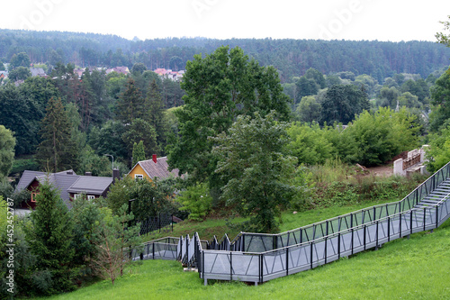 Pedestrian terrace  ramp - descent from the hill to the river. Metal structure on the hill.