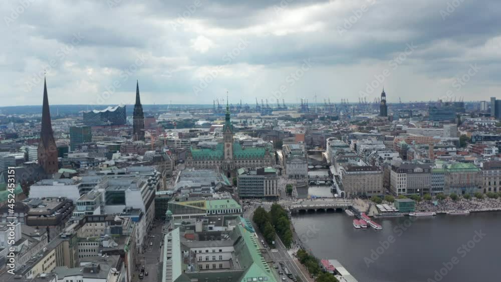 Fly above Binnenalster lake. Aerial view of city centre with old city hall building and churches. Harbour cranes in background. Free and Hanseatic City of Hamburg, Germany Fly above Binnenalster lake. Aerial view of city centre with old city hall building and churches. Harbour cranes in background. Free and Hanseatic City of Hamburg, Germany