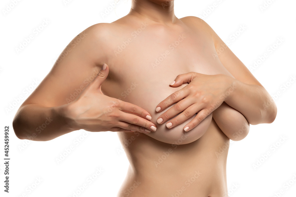 a woman with big breasts makes a self check