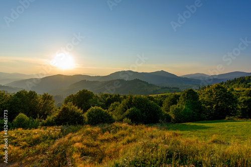 Amazing mountain landscape with colorful vivid sunset on the cloudy sky