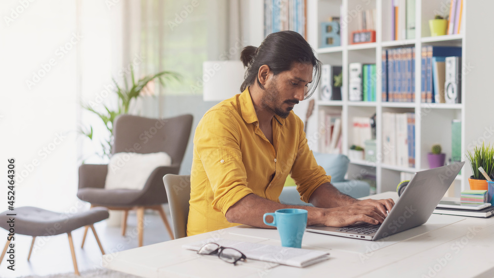 Man sitting at desk and working with his laptop Man sitting at desk and working with his laptop