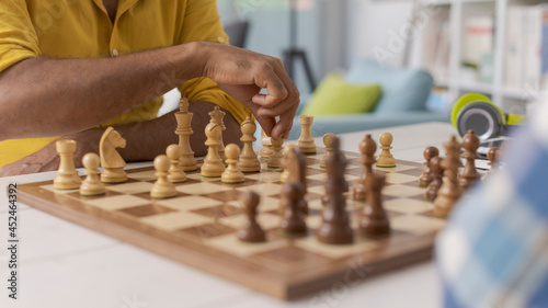 Friends playing chess at home