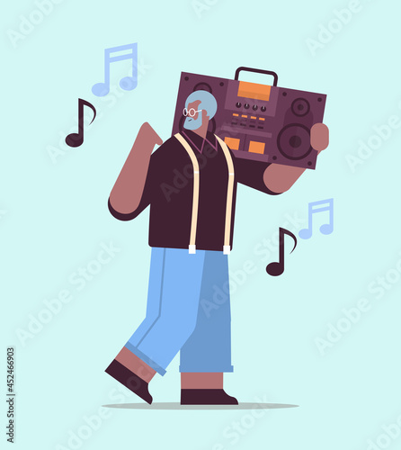 senior african american man with bass clipping ghetto blaster recorder listening music grandfather having fun