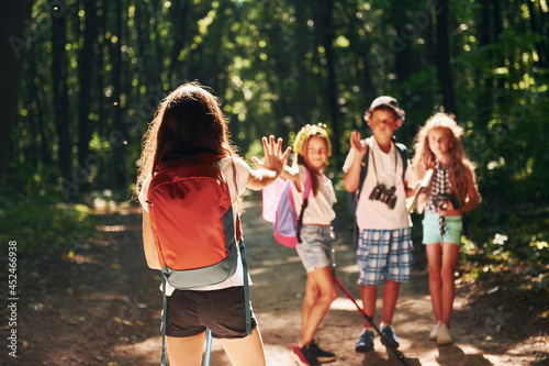 Ready for adventure. Kids strolling in the forest with travel equipment