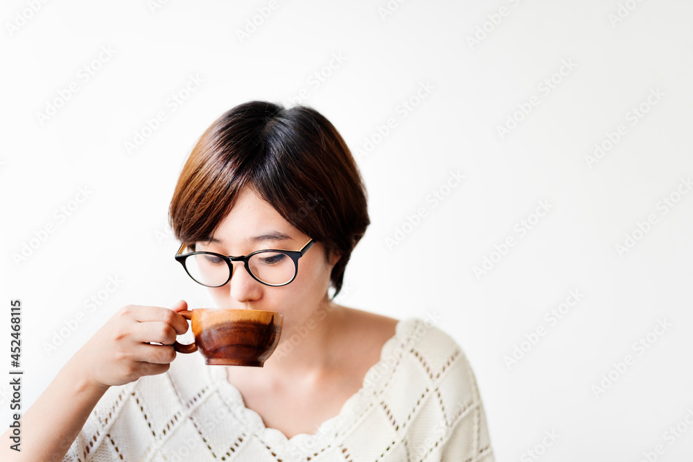 Asian woman drinking coffee with wooden cup Asian woman drinking coffee with wooden cup