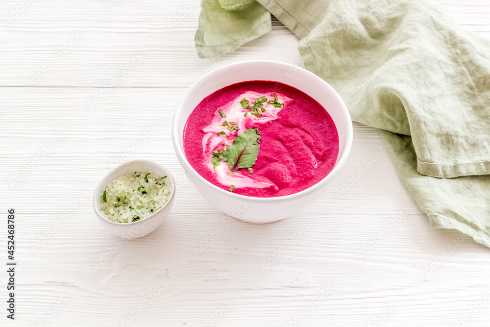 Red vegetarian beet soup in white bowl with sour cream Red vegetarian beet soup in white bowl with sour cream