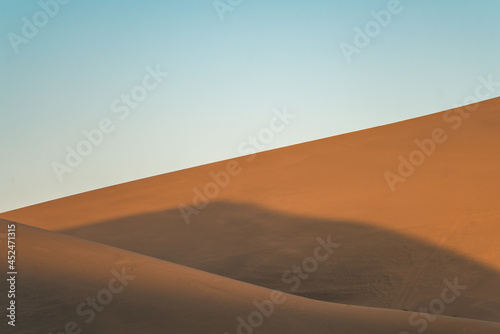 The sunset view of the dunes in deserts in Dunhuang, China. © Zimu