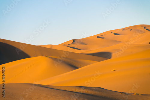 The sunset view of the dunes in deserts in Dunhuang, China.