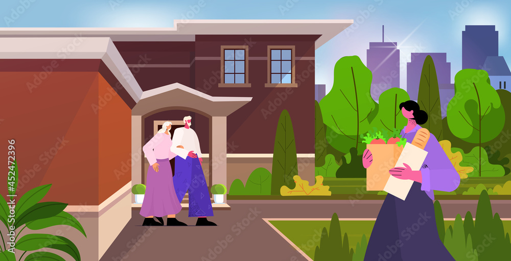 friendly nurse or volunteer bringing food to senior couple home care services healthcare and social support concept friendly nurse or volunteer bringing food to senior couple home care services healthcare and social support concept