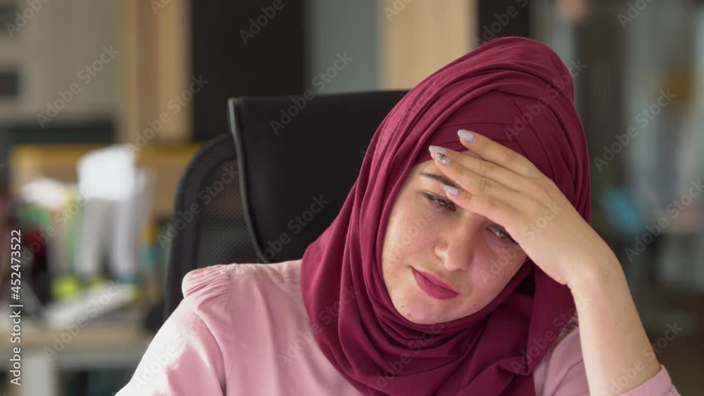 Sad modern muslim business woman in hijab in office. Depression, stress, doubt, depression, denial, crisis, melancholy, sadness at work Sad modern muslim business woman in hijab in office. Depression, stress, doubt, depression, denial, crisis, melancholy, sadness at work