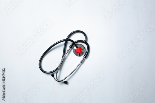 flat lay red heart white stethoscope on white Doctor's table. health concept. Copy space