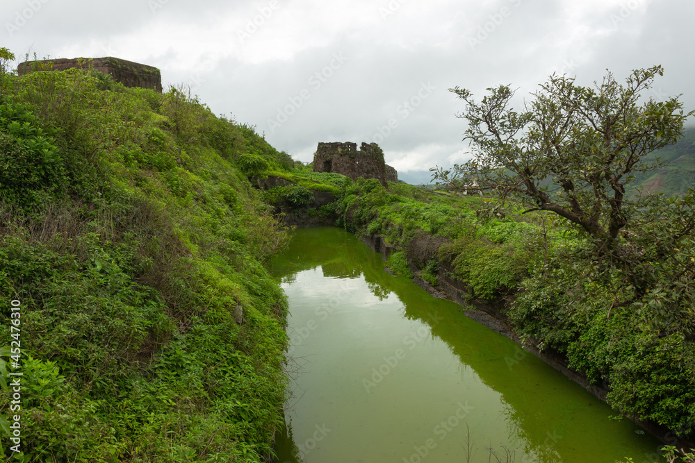 One of the two rock cut water cisterns on the top of Hatgad fort, Nashik, Maharashtra, India. The water is available round the year