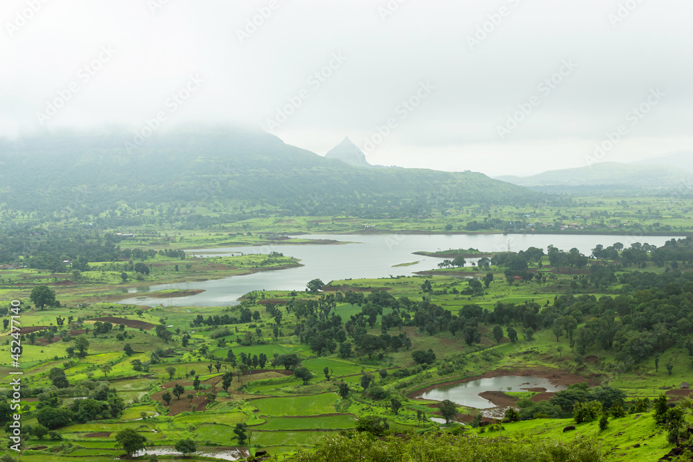 View of Tringalwadi irrigation dam backwaters and fields, Nashik, Maharashtra, India.