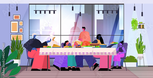 multi generation family celebrating happy thanksgiving day people sitting at table having traditional dinner
